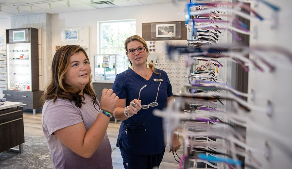 a young girl looking at eyewear in Family Eye Care's Bristol optical