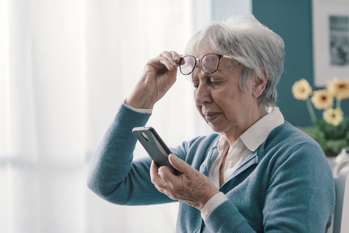 older woman struggling to see phone