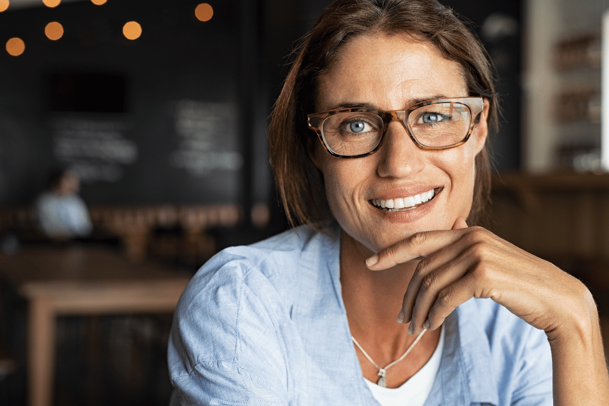 woman smiling and wearing glasses