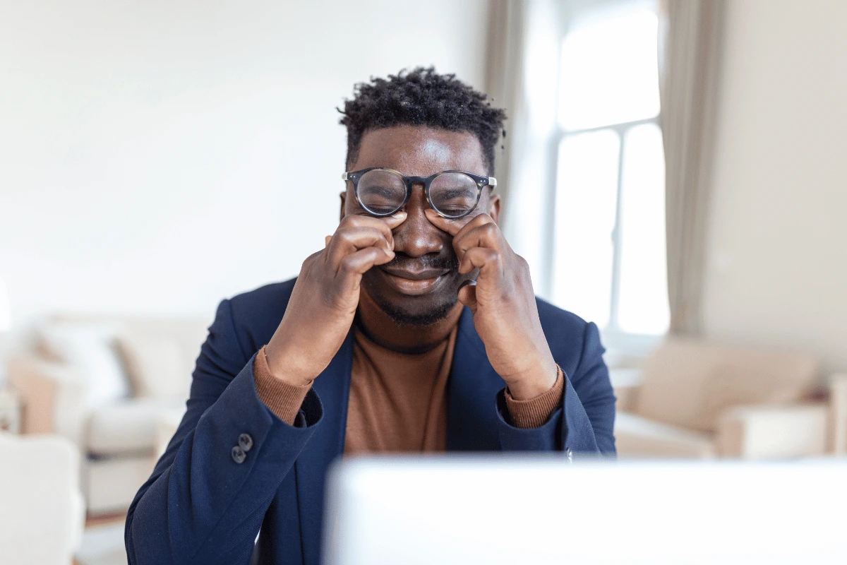 a man suffering from dry eye and rubbing his eyes