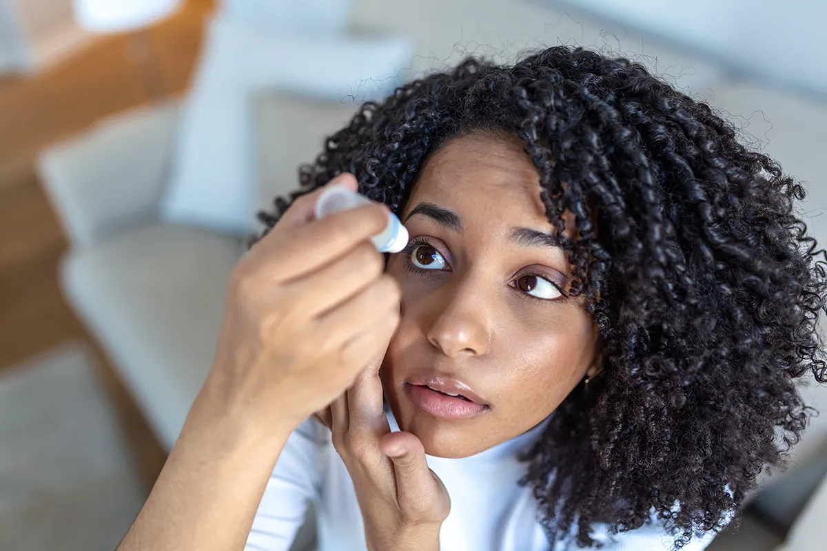 a woman putting in eye drops for dry eye
